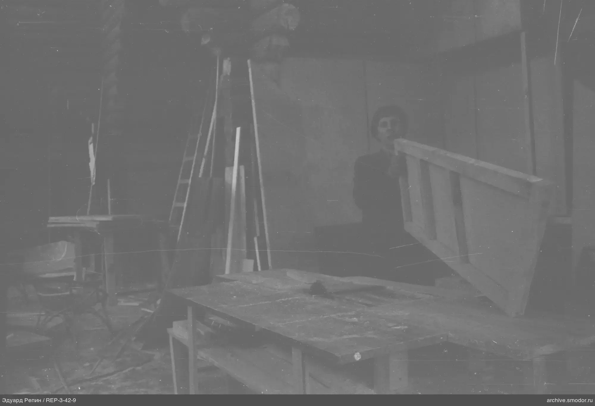 Man with wooden structure in workshop