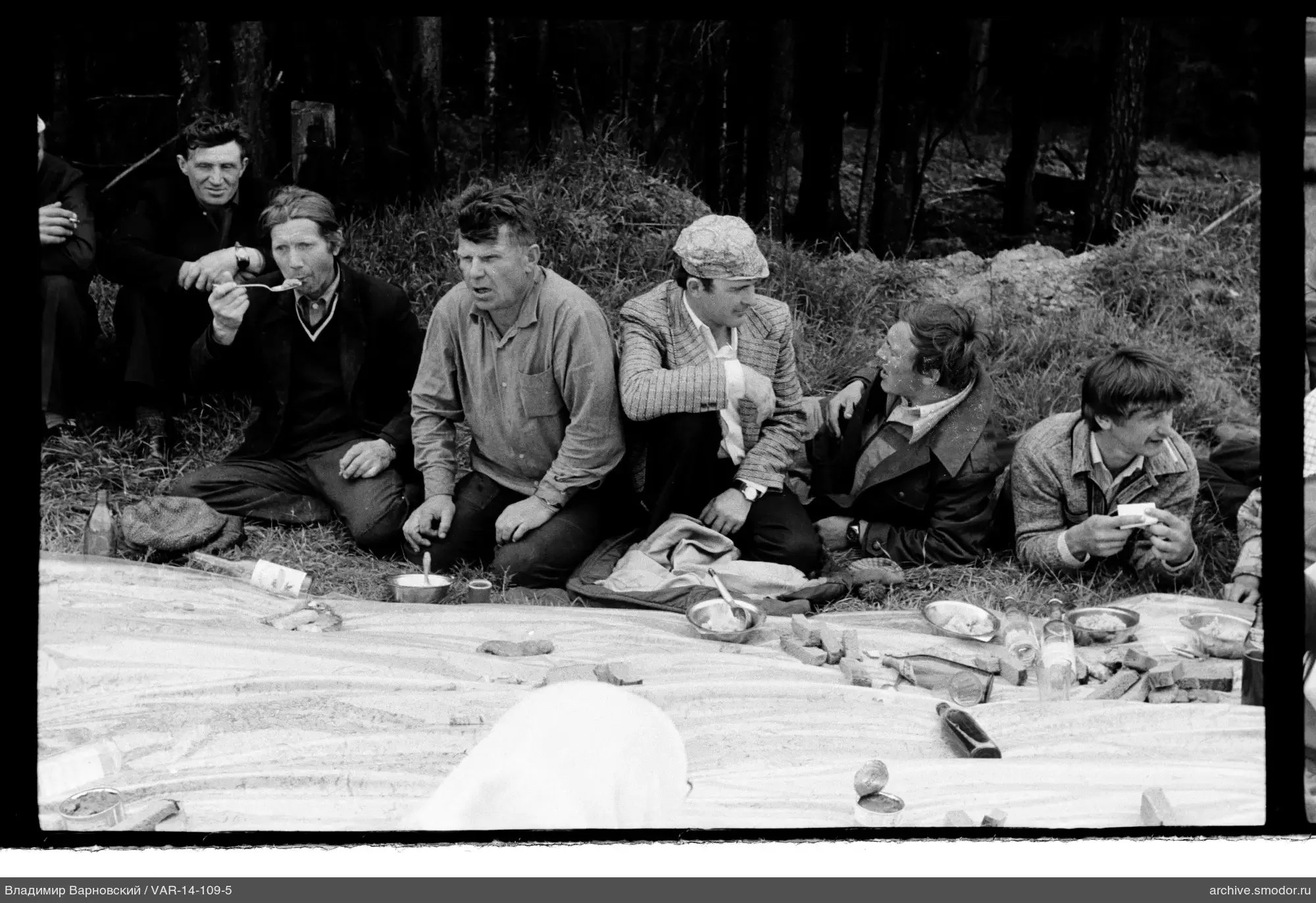 Group of men sitting on the grass