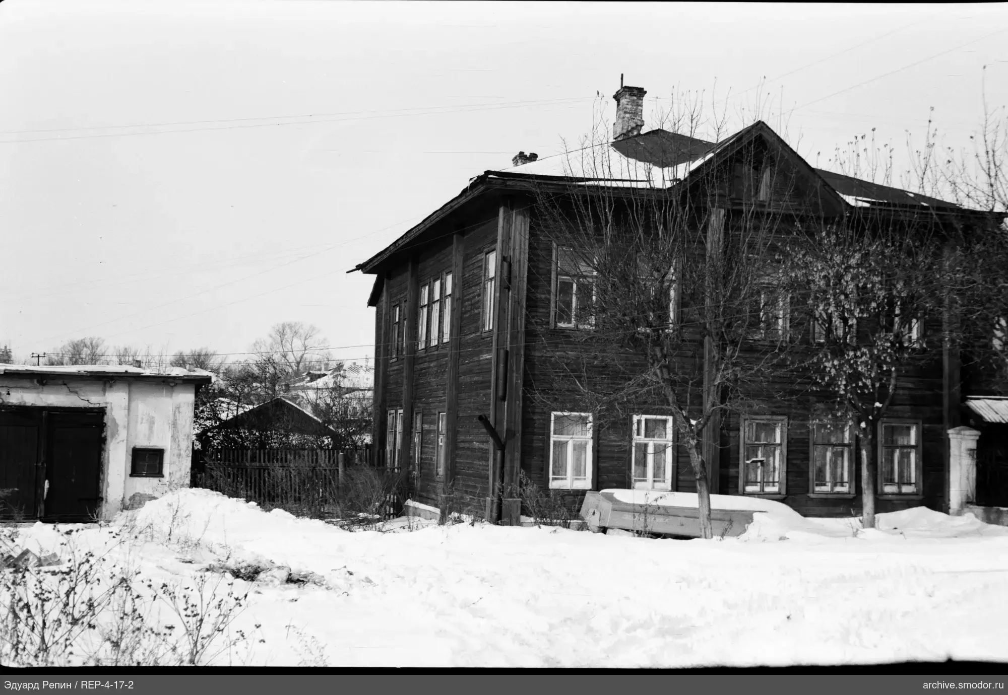 Two-story wooden house with mansard window