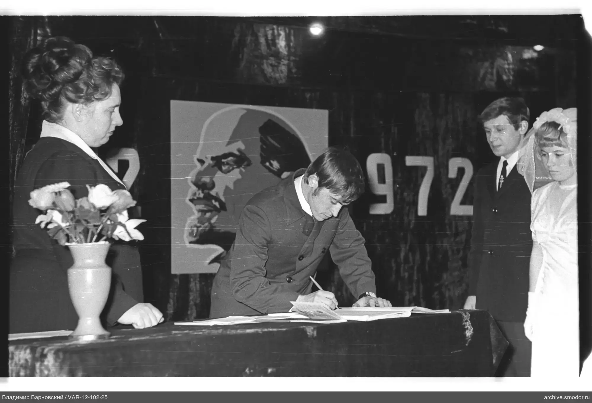 Man signing documents at an event