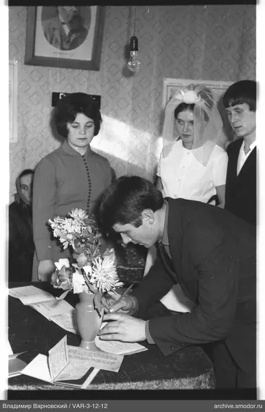 Man signing documents at an event
