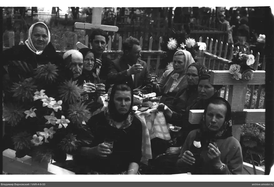 Group portrait around a table with food and drinks