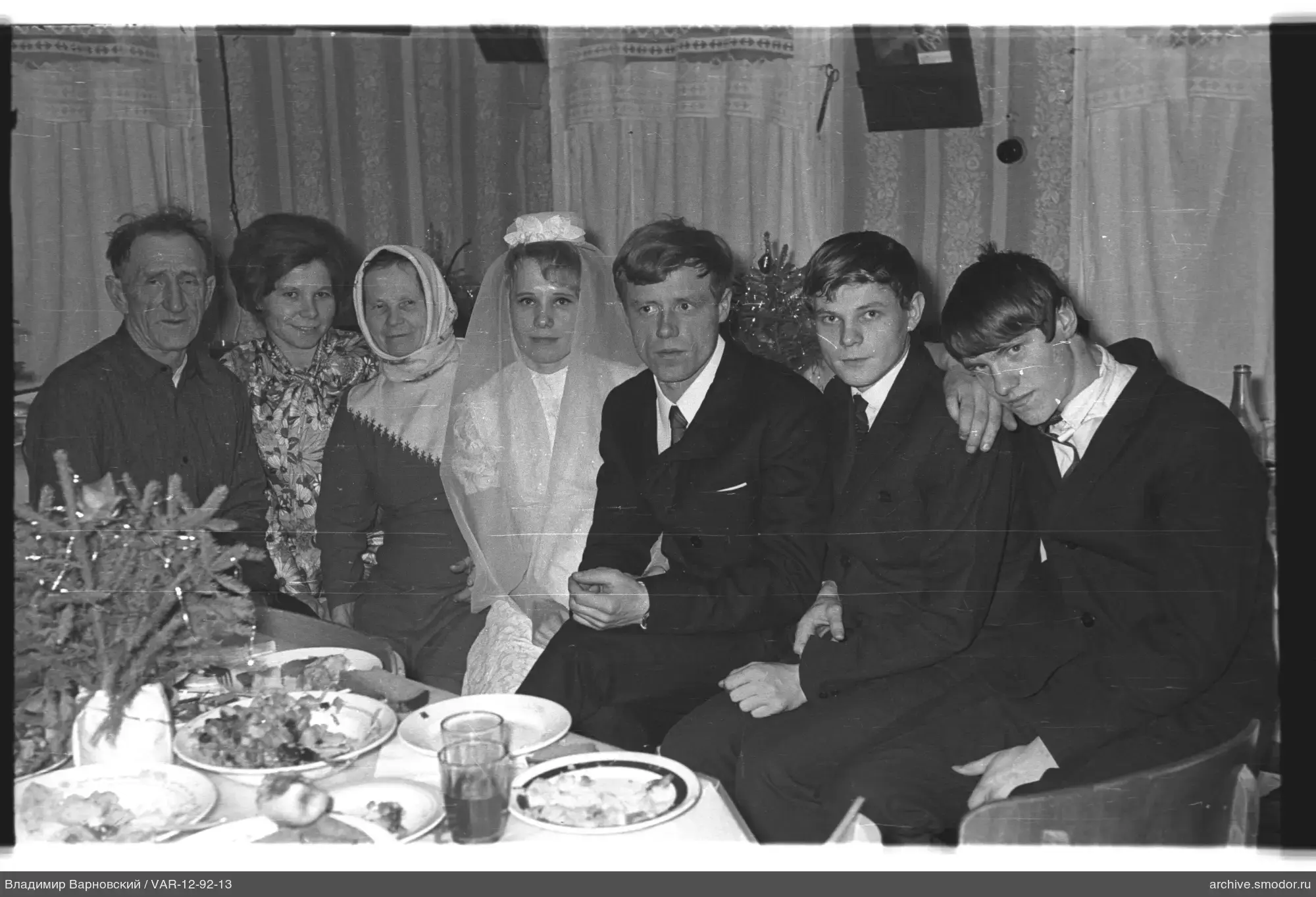 Group portrait at table with Christmas tree