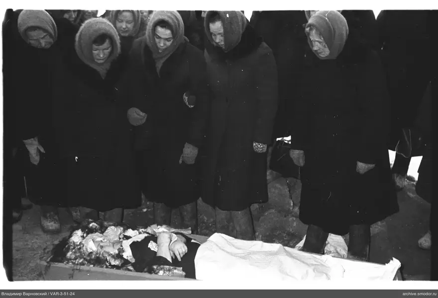 Group of women leaning over a body