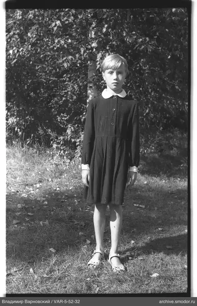 Mädchen im dunklen Kleid auf Gras