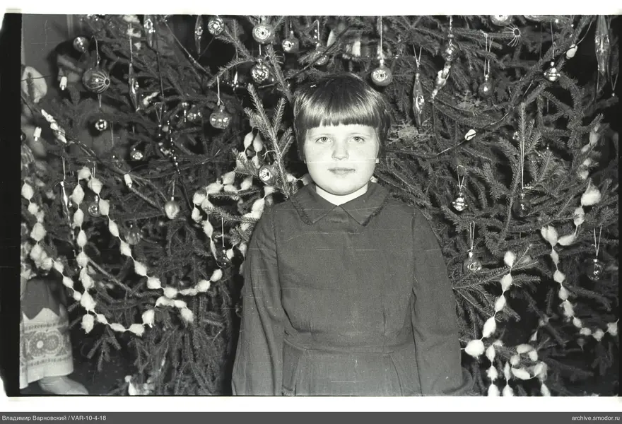 Mädchen vor geschmücktem Weihnachtsbaum
