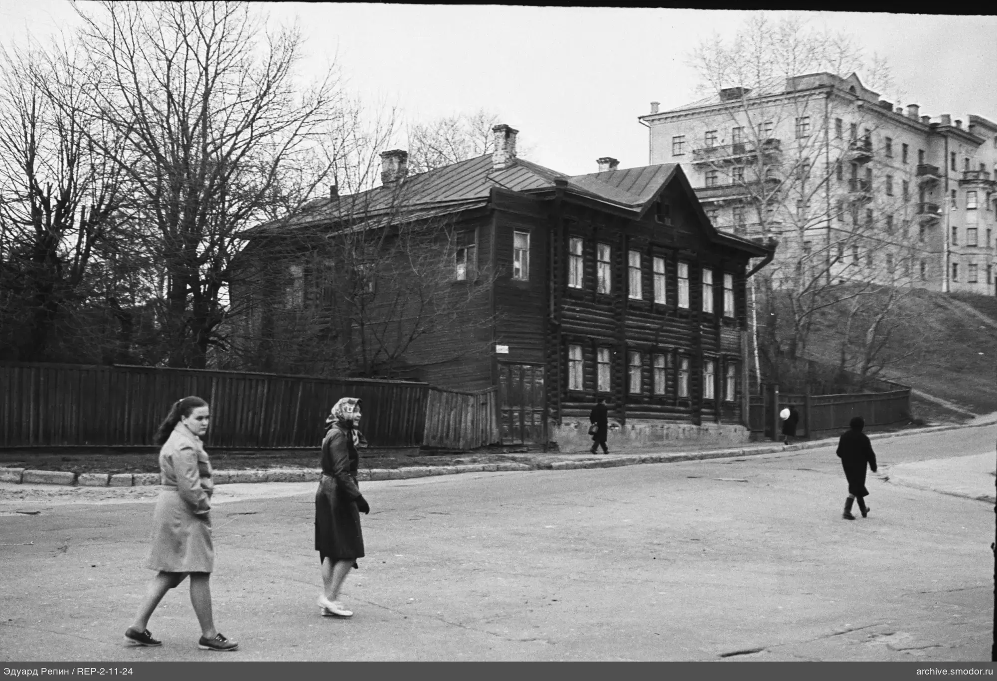 Pedestrians on the street near wooden building