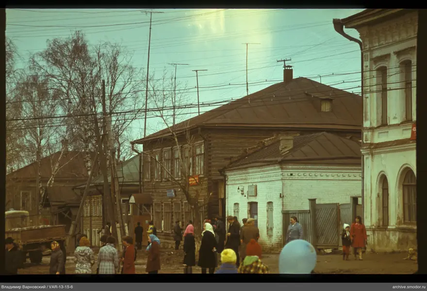 Group of people on a street with houses