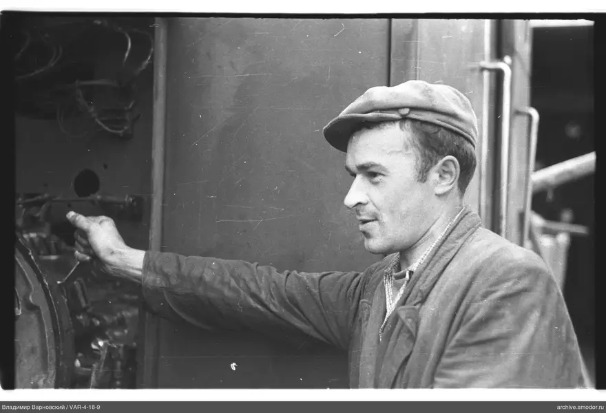 Man with lever at metal surface
