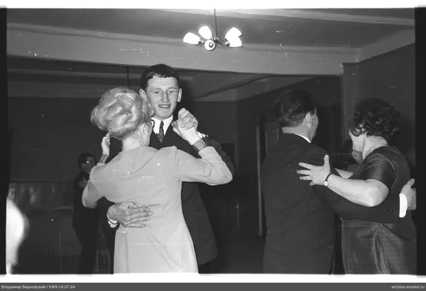 Two dancing couples indoors
