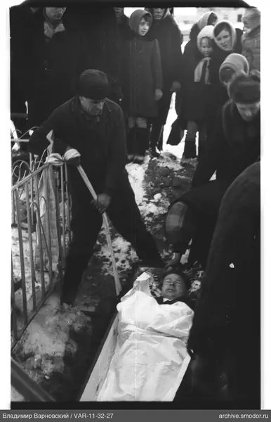 Man digging near a coffin