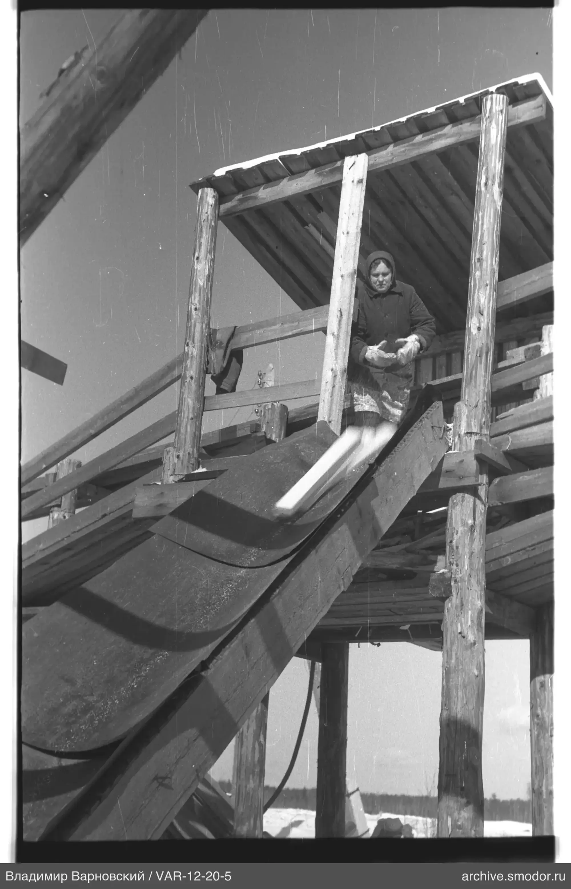 Woman with object at wooden slide