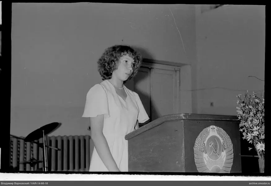 Woman at a podium with USSR emblem