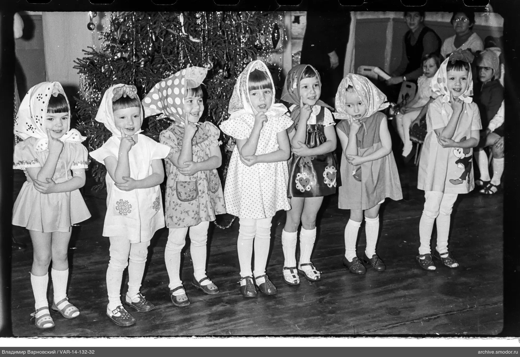 Group portrait of girls in front of a Christmas tree