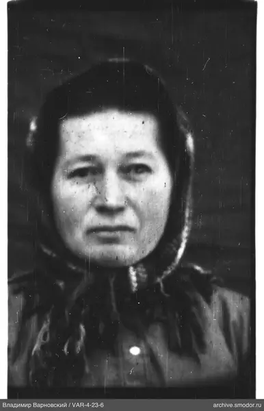 Portrait of a woman in dark clothing and headscarf