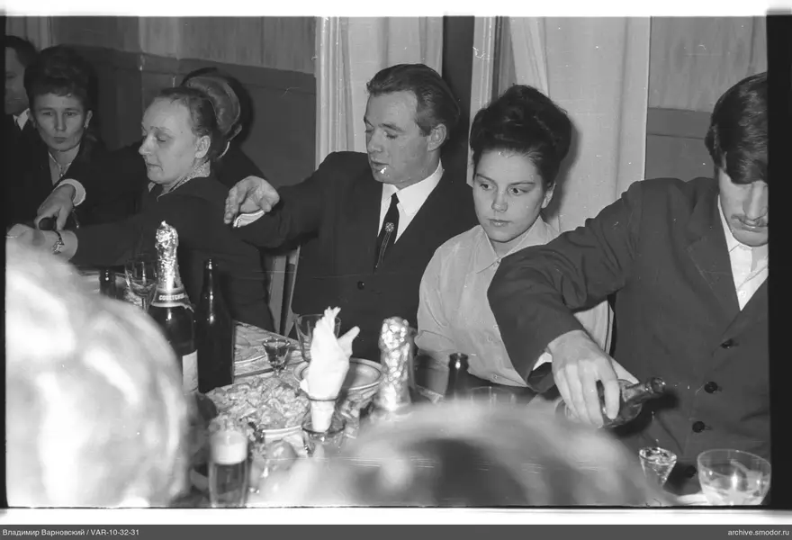 Group sitting at a table with drinks and snacks