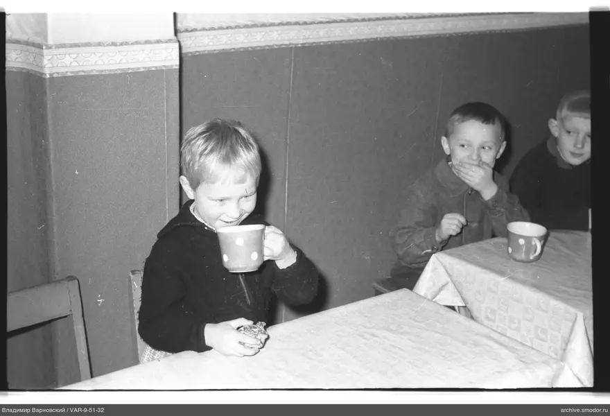 Three boys sitting at tables