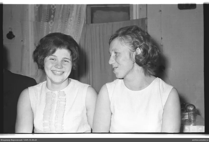 Two women in sleeveless tops